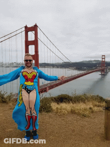Man In Wonder Woman Costume In Front Of Bridge GIF