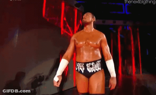 Man In Wrestling Outfit Before Crowd In Dark Room GIF
