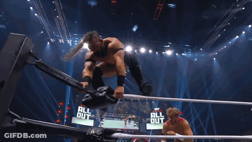 Man In Wrestling Ring Holding TNT Microphone GIF