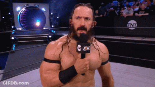 Man In Wrestling Ring Holding TNT Microphone GIF