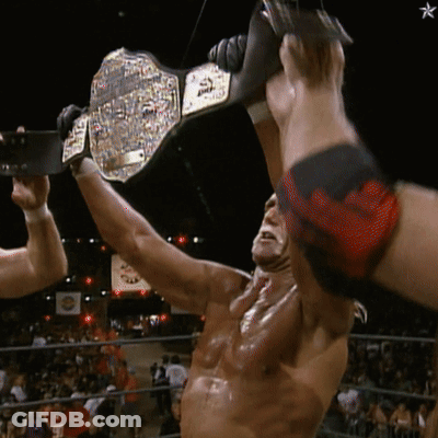 Man In Wrestling Ring Holding World Heavyweight Champion Belt GIF