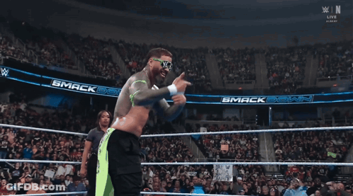 Man In Wrestling Ring Wearing Sunglasses Saying N & E GIF