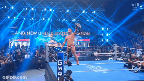 Man In Wrestling Ring With And New United States On Wall GIF