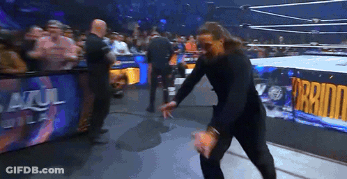 Man In Wrestling Ring With Azul Del Sol Sign GIF