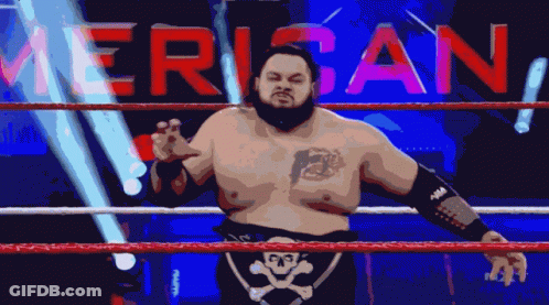 Man In Wrestling Ring With Ericane On Wall GIF
