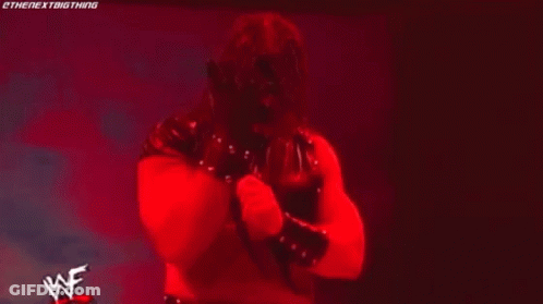 Man In Wrestling Ring With Flame Saying Wrestle GIF
