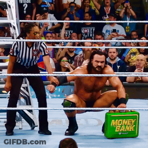 Man In Wrestling Ring With Green Money Bank GIF