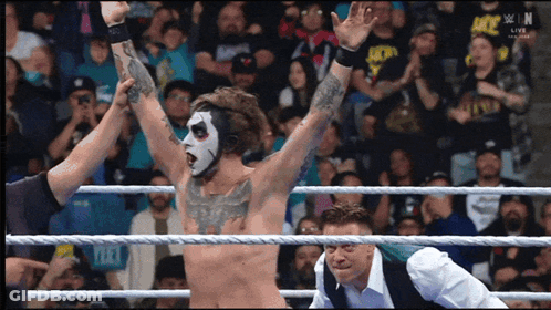 Man In Wrestling Ring With Hands In Air GIF