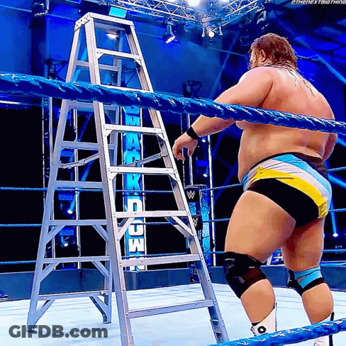 Man In Wrestling Ring With Ladder In Front Of Raw Sign GIF