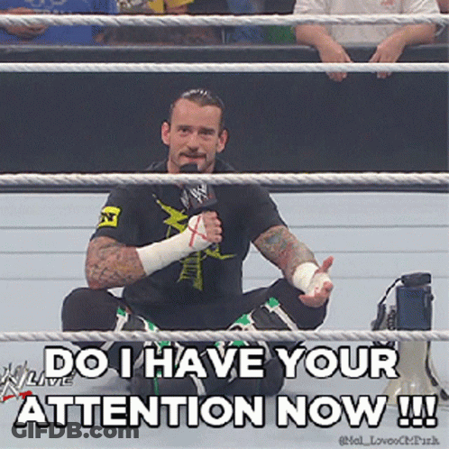 Man In Wrestling Ring With Microphone Says Do I Have Your Attention Now GIF