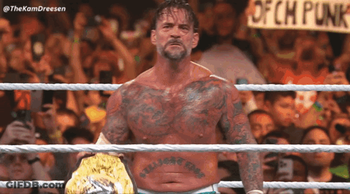 Man In Wrestling Ring With Ofch Punk Sign GIF