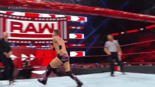 Man In Wrestling Ring With Sign Saying Raw GIF