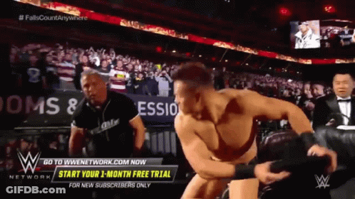 Man In Wrestling Ring With Start Your 1 Month Free Trial Sign GIF