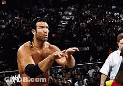 Man In Wrestling Ring With W Logo On Arm GIF