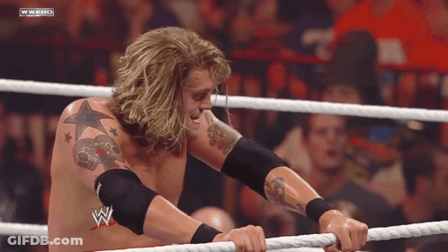 Man In Wrestling Ring With W On Chest GIF