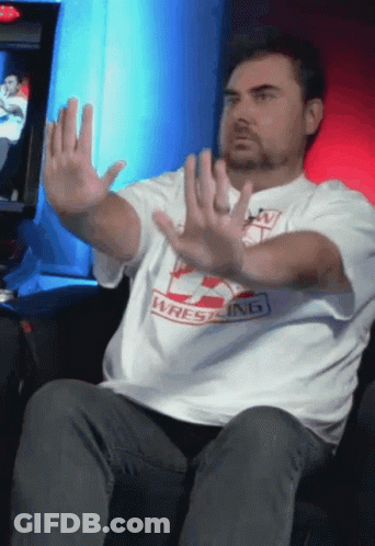 Man In Wrestling Shirt Holding Hands Up GIF