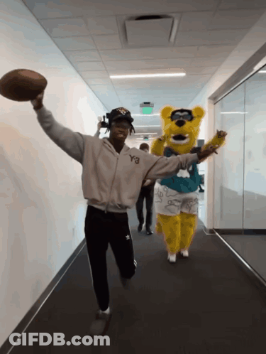 Man In Y3 Jacket Holding Football GIF