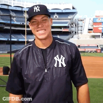 Man In Yankees Jacket And Hat Smiling GIF