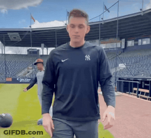 Man In Yankees Shirt In Front Of Stadium GIF