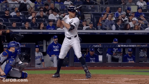 Man In Yankees Uniform Holding Bat GIF