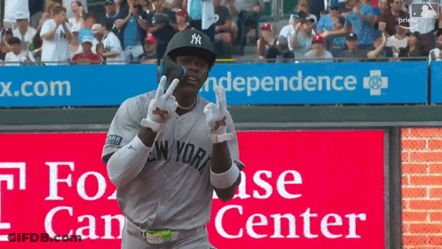 Man In Yankees Uniform In Front Of Independence Sign GIF
