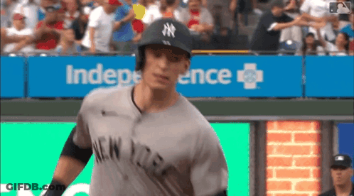 Man In Yankees Uniform In Front Of Independence Sign GIF