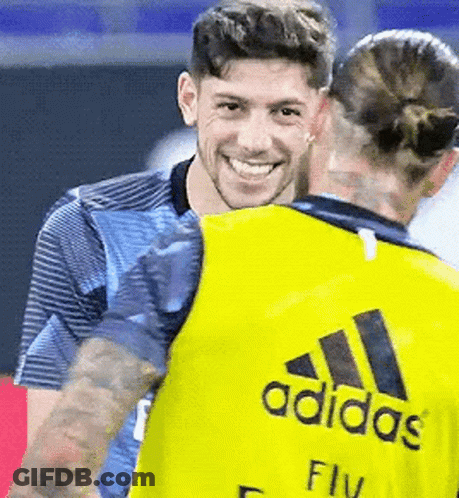 Man In Yellow Adidas Shirt Hugging Woman GIF