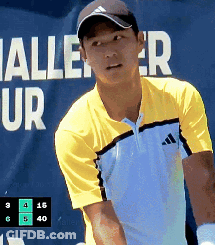 Man In Yellow Adidas Shirt Playing Tennis In Front Of Halle Ur Banner GIF