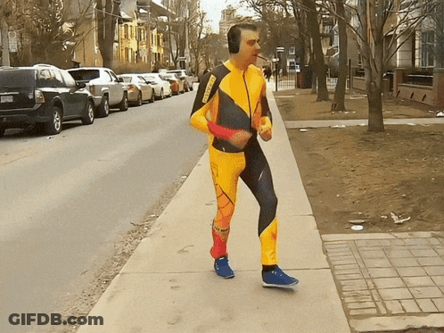 Man In Yellow And Black Jumpsuit With Headphones GIF