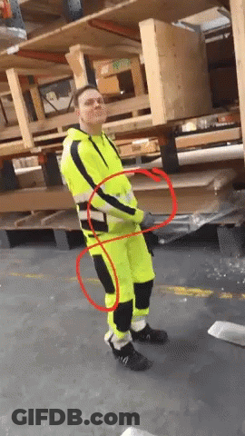 Man In Yellow And Black Safety Suit By Wooden Pallets GIF