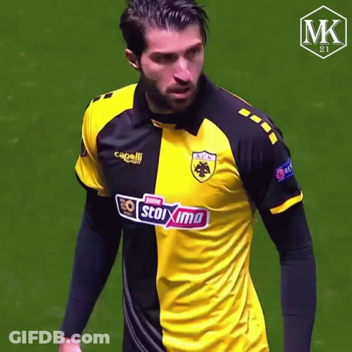 Man In Yellow And Black Stoixima Shirt GIF