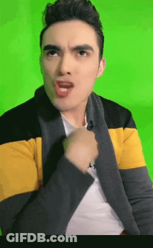 Man In Yellow And Black Striped Jacket Making Funny Face GIF