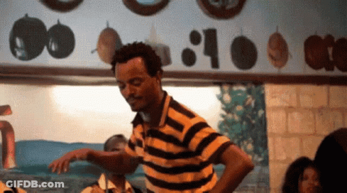 Man In Yellow And Black Striped Shirt Dancing GIF
