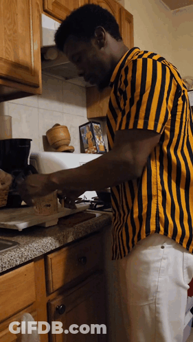 Man In Yellow And Black Striped Shirt Preparing Food GIF