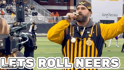 Man In Yellow And Black Striped Shirt Sings Let's Roll Neers GIF