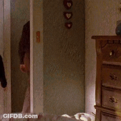 Man In Yellow And Black Striped Shirt Using Computer GIF