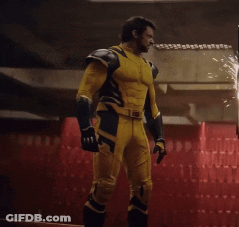Man In Yellow And Black Superhero Suit Facing Fire GIF