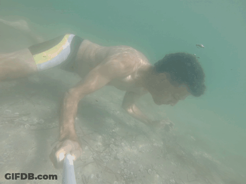 Man In Yellow And Black Swimsuit Swimming GIF