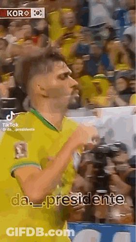 Man In Yellow And Green Jersey Dancing Before Crowd GIF