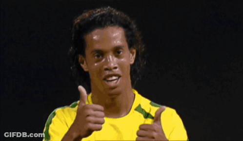 Man In Yellow And Green Shirt Looking Down GIF