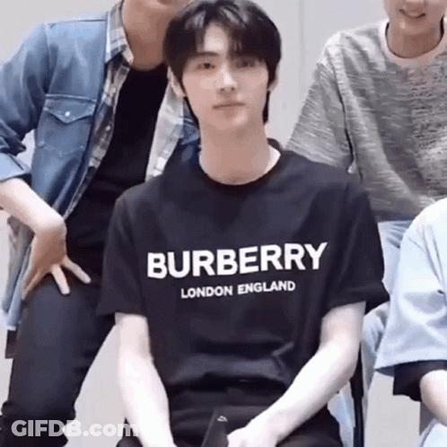Man In Yellow And Green Shirt Looking Down GIF