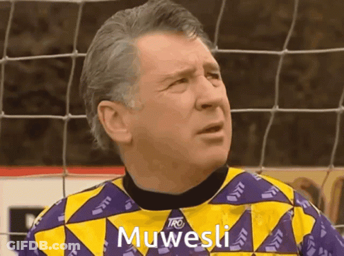 Man In Yellow And Purple Shirt Saying Muwesi GIF
