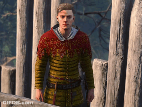 Man In Yellow And Red Sweater Standing By Fence GIF