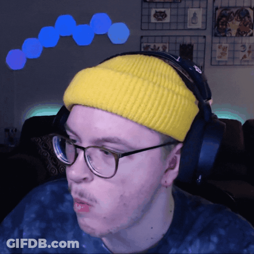 Man In Yellow Beanie And Headphones Looking Left GIF