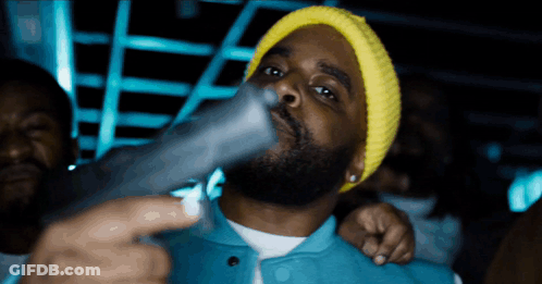Man In Yellow Beanie Holding Gun GIF