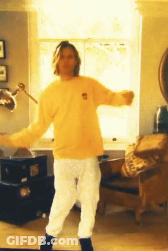 Man In Yellow Bear Shirt Dancing In Living Room GIF