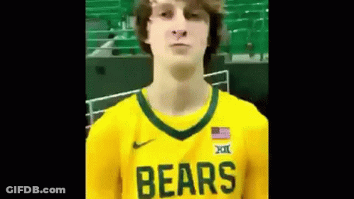 Man In Yellow Bears Jersey In Front Of Green Bleachers GIF