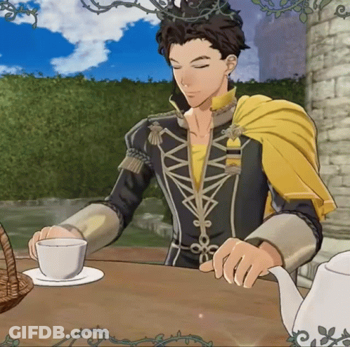 Man In Yellow Cape Sitting At Table With Tea GIF