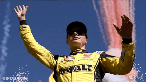 Man In Yellow DeWalt Jacket In Front Of Fireworks GIF