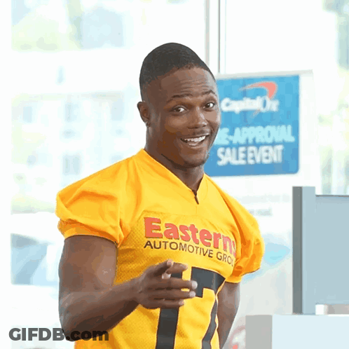 Man In Yellow Eastern Automotive Group Jersey Pointing At Camera GIF